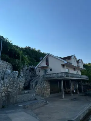 a building with stairs and a stone wall at Lake Skadar Paradise in Podgorica