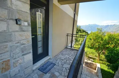 a front door of a house with a balcony at Radgost Kotor Apartments in Kotor