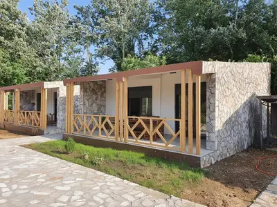 a house being constructed with wood and stone at Sabina Bungalow - Long Beach in Ulcinj