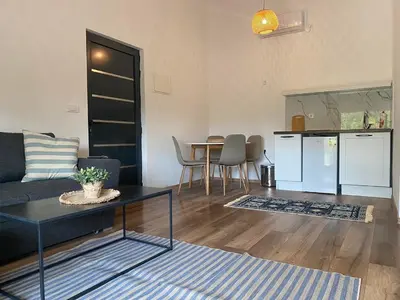 a living room with a couch and a table at Sabina Bungalow - Long Beach in Ulcinj