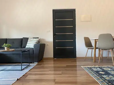 a living room with a couch and a table at Sabina Bungalow - Long Beach in Ulcinj