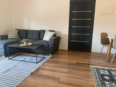 a living room with a couch and a table at Sabina Bungalow - Long Beach in Ulcinj