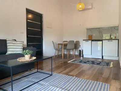 a living room with a couch and a table at Sabina Bungalow - Long Beach in Ulcinj