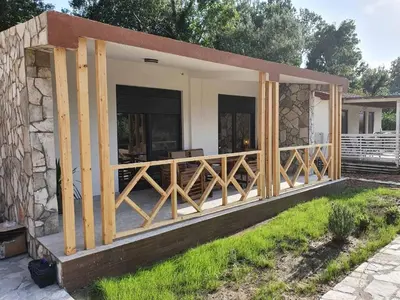 a house being constructed with a wooden deck at Sabina Bungalow - Long Beach in Ulcinj