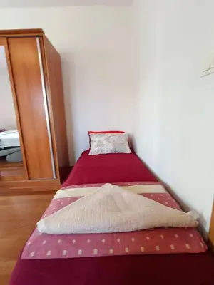 a small bedroom with two beds in it at Center Studio in Petrovac na Moru