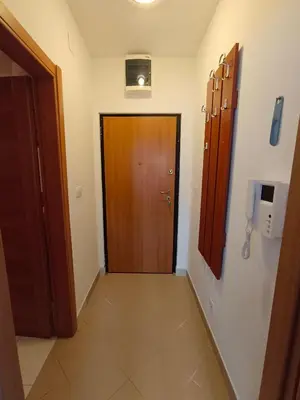 a hallway with a wooden door in a room at Center Studio in Petrovac na Moru