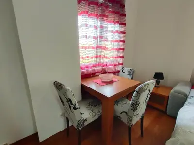 a dining room table with two chairs and a window at Center Studio in Petrovac na Moru