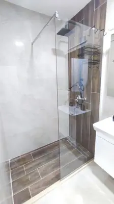 a shower with a glass door in a bathroom at Apartments LORA Susanj #39 in Bar