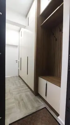 a room with a hallway with white cabinets and a door at Apartments LORA Susanj #39 in Bar