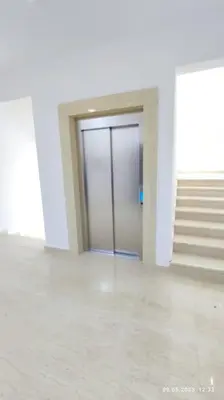 a hallway with a door and stairs in a building at Apartments LORA Susanj #39 in Bar