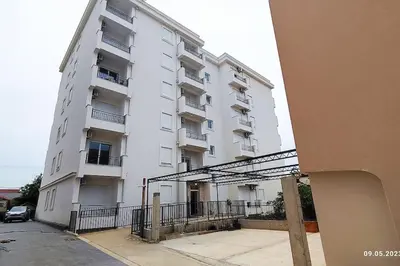 a large white apartment building with a balcony at Apartments LORA Susanj #39 in Bar