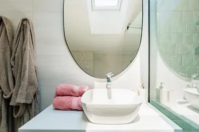 a bathroom with a white sink and a mirror at 2-floor penthouse with stunning views in Budva