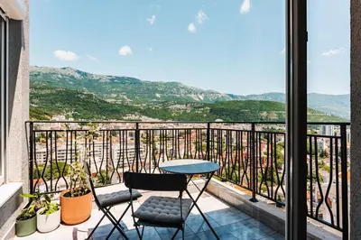 a table and two chairs on a balcony with a view at 2-floor penthouse with stunning views in Budva
