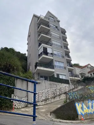 a tall apartment building with a fence in front of it at 2-floor penthouse with stunning views in Budva