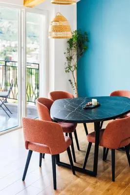 a dining room with a blue table and chairs at 2-floor penthouse with stunning views in Budva
