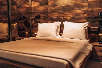 a bed with white sheets and pillows in a room at Carevic Resort & Villas in Budva