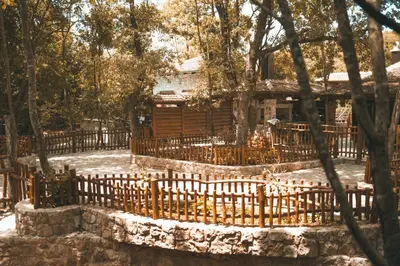 a wooden fence in front of a house at Carevic Resort & Villas in Budva