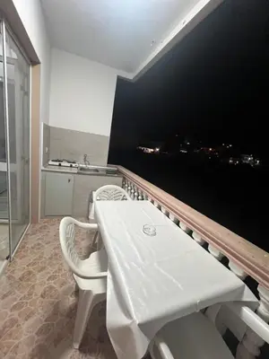 a dining room with a white table and chairs at Keon in Ulcinj