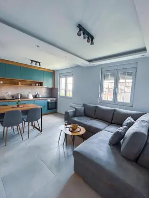 a living room with a couch and a table at Sunset Apartment in Kotor