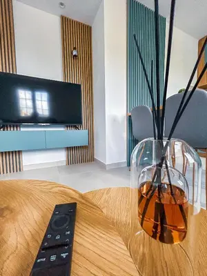 a vase sitting on a table with a remote control at Sunset Apartment in Kotor