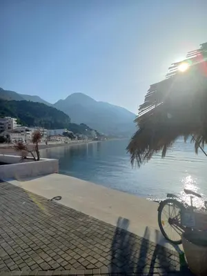 a bike parked next to a body of water at STELLA di mare in Sutomore