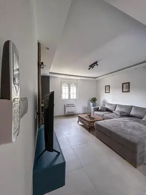 a living room with a couch and a tv at Sunrise Apartment in Kotor