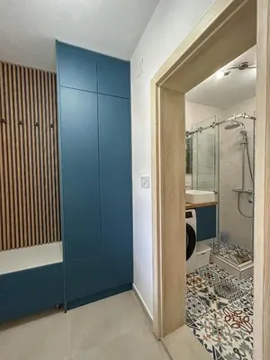 a bathroom with a blue cabinet and a sink at Sunrise Apartment in Kotor