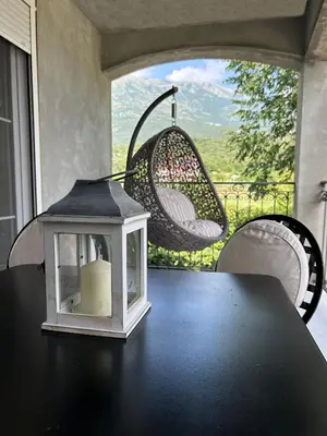 a table with a candle and a lantern on a table at Sunrise Apartment in Kotor