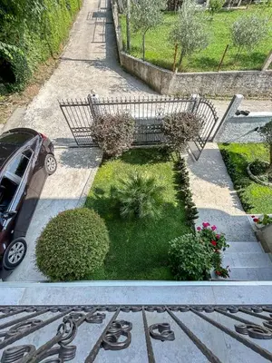 a garden with a bench and some plants at Sunrise Apartment in Kotor