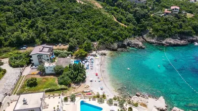 an aerial view of a beach with people in the water at Bungalovi Arabela in Utjeha