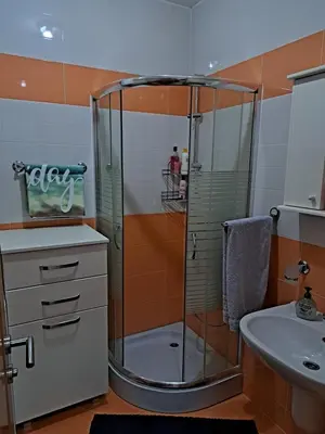a shower with a glass door in a bathroom at Petrovac Studio Apartment Ana in Petrovac na Moru