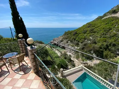 a balcony with a view of the ocean at Семейный комплекс для отдыха in Pečurice