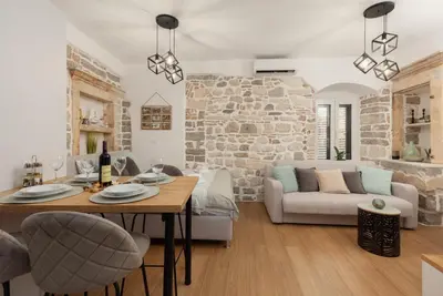 a living room with a table and a couch at Apartman Maestral in Kotor