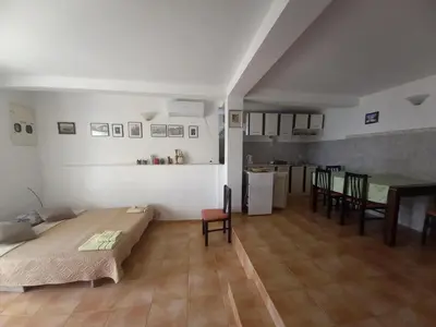 a room with a bed and a table and chairs at Apartments & Rooms Villa Anastasija in Ulcinj