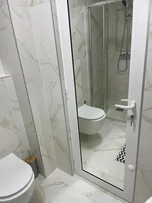 a bathroom with a toilet and a glass shower at Villa Draga in Ulcinj