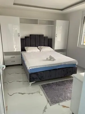 a bedroom with a bed in a white room at Villa Draga in Ulcinj