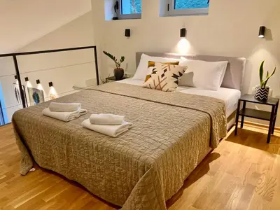a bedroom with a large bed with towels on it at The View apartment 2 in Petrovac na Moru