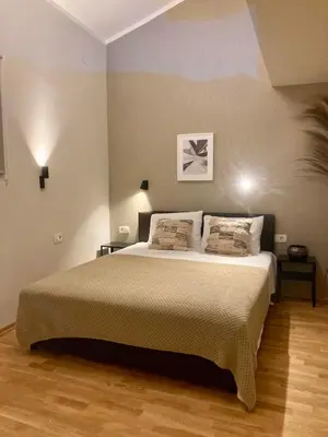 a bedroom with a large bed with two pillows at The View apartment 2 in Petrovac na Moru