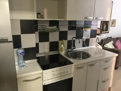 a kitchen with a sink and a stove top oven at Stan Budva - Potkosljun in Budva