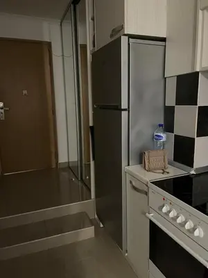 a kitchen with a stainless steel refrigerator and a stove at Stan Budva - Potkosljun in Budva