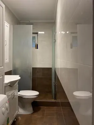 a bathroom with a shower and a toilet and a sink at Stan Budva - Potkosljun in Budva