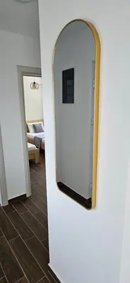 a mirror on a wall in a room at KenDar Family Apartments in Ulcinj