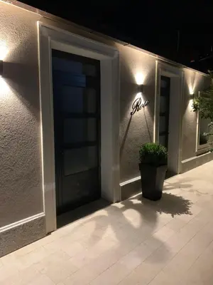 a front door of a building with a potted plant at ROSE Downtown in Podgorica