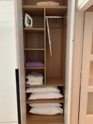 a closet with folded towels in it at ROSE Downtown in Podgorica