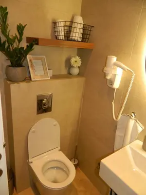 a small bathroom with a toilet and a sink at ROSE Downtown in Podgorica