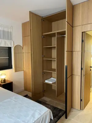 a bedroom with a bed and a closet at ROSE Downtown in Podgorica