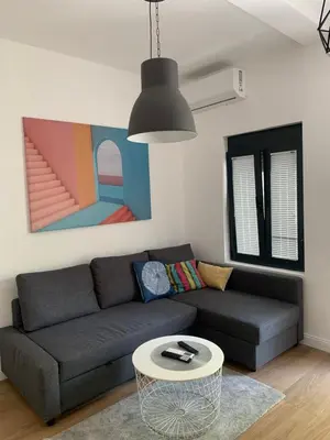 a living room with a couch and a table at ROSE Downtown in Podgorica