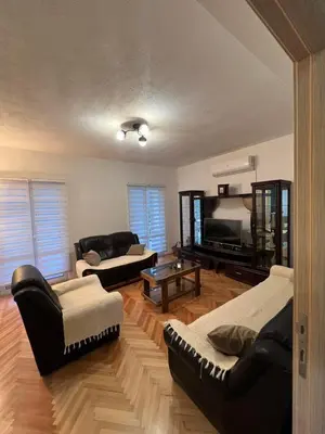 a living room with two couches and a television at Villa Bubanja with shared pool in Kotor