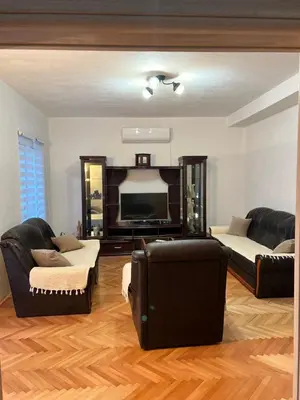 a living room with two couches and a flat screen tv at Villa Bubanja with shared pool in Kotor