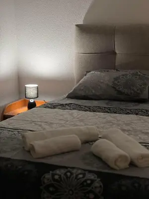 two towels laying on a bed with a pillow at Villa Bubanja with shared pool in Kotor